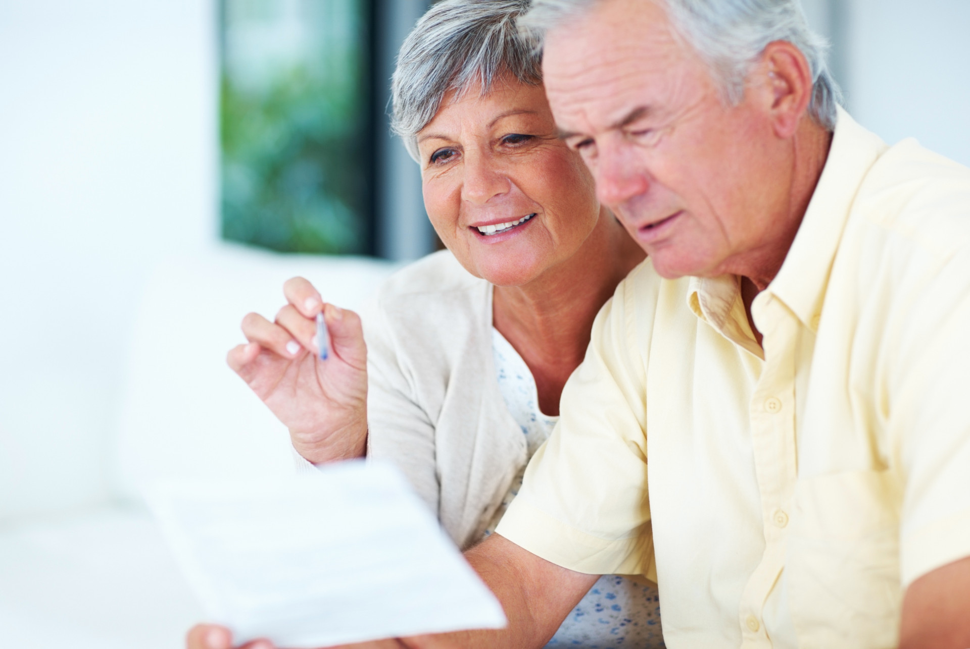 Mann und Frau schauen interessiert gemeinsam auf ein Informationsblatt